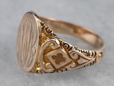 This antique Ostby Barton signet ring is stunning! Deeply carved designs along the shoulders form ornate textures, enhanced by a granulated finish that gives the 10k gold a luxurious look. We've left the original monogram – a stylish hand engraved French script! Please note that this signet ring has its original monogram, and unfortunately, this piece cannot be altered without affecting the quality of the piece. Please feel free to contact us to help you find your perfect signet ring in your sty Antique Carved Signet Ring For Ceremonial Use, Formal Carved Signet Ring In 14k Gold, Carved 14k Gold Signet Ring For Formal Occasions, Carved Signet Ring In 14k Gold For Formal Occasions, Antique Engraved Signet Ring For Ceremonial Occasions, Luxury Oval Signet Ring With Intricate Design, Antique Round Signet Ring With Intricate Design, Antique Carved Signet Ring For Formal Occasions, Formal Carved Yellow Gold Signet Ring