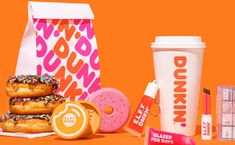 the dunkin donuts are next to a cup of coffee and some other items