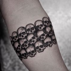 a man's arm with skulls on it