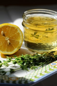 a glass jar filled with lemon and herbs