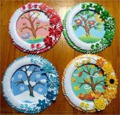 four paper plates decorated with trees and flowers