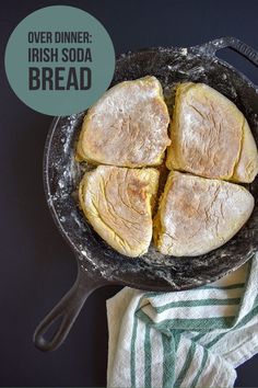 four pieces of bread are in a cast iron skillet on a striped dish towel