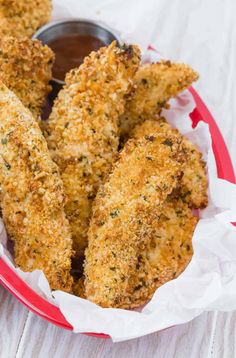 fried chicken sticks with dipping sauce in a red bowl