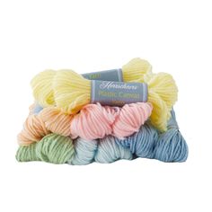 six skeins of yarn in different colors and sizes, with the label on top