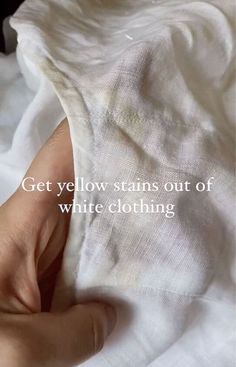 someone is holding their white shirt with the words get yellow stains out of white clothing