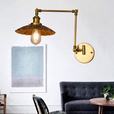 a living room with a couch, chair and wall light in the middle of it