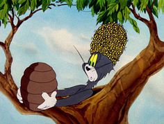 a cartoon character sitting on top of a tree with a large ball in his hand