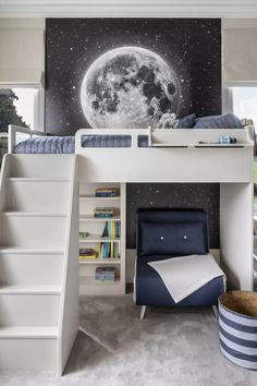 a bedroom with a loft bed and stairs leading up to the top floor, next to a book shelf filled with books