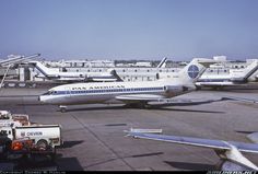 several airplanes are parked on the tarmac at an airport with other planes in the background