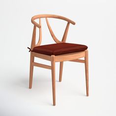 a wooden chair with a red cushion on the seat and armrests, against a white background