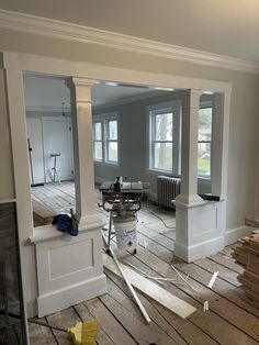 an empty room is being remodeled with wood flooring and construction equipment on the ground