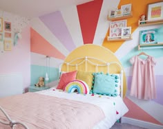 a bedroom decorated in pastel colors and striped walls