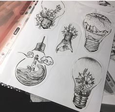 some stickers that are sitting on top of a piece of paper with flowers and lightbulbs