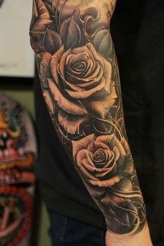 a man's arm with roses on it