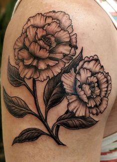 a woman's shoulder with flowers on it