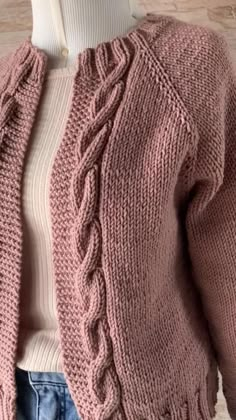 a woman wearing a pink cardigan sweater and jeans