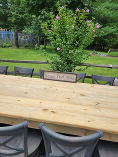 a wooden table with chairs around it and a sign that says unique creations on the top