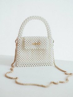 Pearl beaded bags are luxurious and sophisticated accessories that are suitable for formal occasions, such as weddings, proms, and black-tie events.  However, they can also add a touch of glamour and femininity to more casual outfits and can be worn for a night out or a dinner party. The bag is woven from fishing line, which can withstang 25 kg. It is very reliable as it closes with a magnetic clasp.  100% handmade Material: acrylic pearl beads 8 mm  We offer 2 sizes of this handbag: 1 Size:  > Pearl Handbag, Prom Purse, Bridal Handbags, Wedding Purse, Purse Gift, Pearl Bag, Beaded Bag, Luxury Purses, Valentines Day Gifts For Her