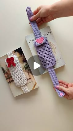 someone is holding a crocheted tie on top of a book with an image of a woman's hand