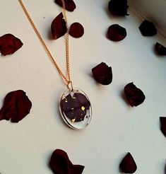 This one-of-a-kind handmade oval pendant features a delicate deep red rose petal which was harvested and dried by hand and then preserved in clear resin encased with shimmering Gold flakes. It's a beautiful accessory that adds a touch of sophistication and romance to any outfit allowing you to take a fragment of nature with you wherever you go. Please note that each piece of our jewellery is lovingly handcrafted and completely unique. As a result, there may be small bubbles or marks in the resin Red Rose Petals, Necklace Resin, Handmade Rose, Resin Jewellery, Rose Rouge, Rose Pendant, Rose Necklace, Gold Flakes, Oval Pendant