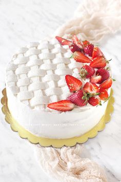 a white cake with strawberries on top