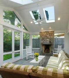 a living room filled with furniture and a fire place in the middle of a house