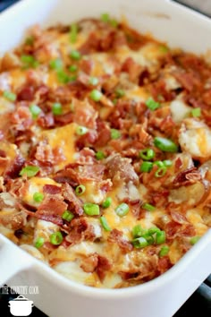 a casserole dish with meat, cheese and green onions