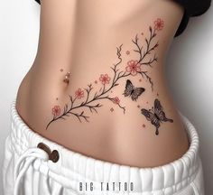 a woman's stomach with flowers and butterflies on the side, behind her belly