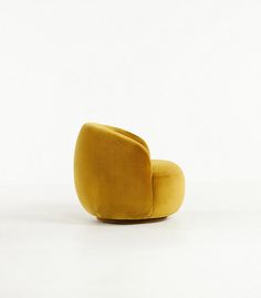 a yellow chair sitting on top of a white floor