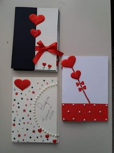 two cards with hearts and pearls on them, one has a red ribbon attached to it