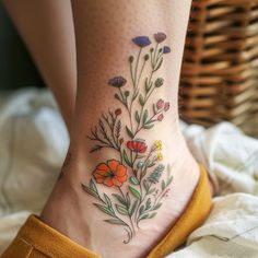 a close up of a person's foot with flowers on it