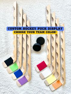 the hockey puck display is made out of wooden slats and has different color options to choose from