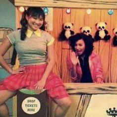 two women are posing in front of an advertisement for the movie, pandas live