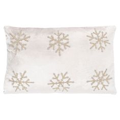 a white pillow with gold snowflakes on it