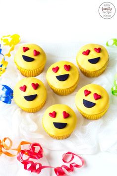 cupcakes with yellow frosting and red hearts on them