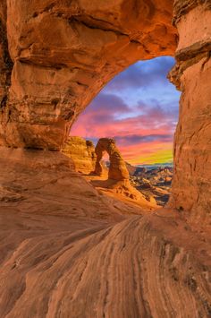 the sun is setting at arches in the desert