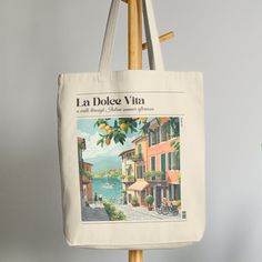 ♥ Evoke the Italian summer with our La Dolce Vita Lemon Print Canvas Tote Bag. Made for beach days and leisurely strolls, this aesthetic essential adds a touch of Mediterranean charm to your summer vibes.  ♥ Carry your essentials in style and embrace the sweet life of summer.  ♥ Gift-worthy: Makes a delightful present for anyone seeking a taste of Italian elegance ♥ This 100% cotton bag comes in one size - 15" x 16" ♥ The bag features 20" handles (made from the same canvas), making it easy to ca Casual Letter Print Canvas Bag For Vacation, Casual Canvas Bag With Letter Print For Vacation, Casual Summer Canvas Shoulder Bag, Casual Canvas Bag For Everyday Summer Use, Casual Everyday Summer Canvas Bag, Casual Canvas Shoulder Bag For Summer, Casual Everyday Canvas Bag For Summer, Summer Canvas Bag For Daily Use, Casual Summer Canvas Bag With Letter Print