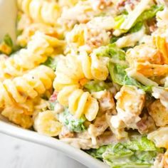 pasta salad with chicken and lettuce in a white bowl