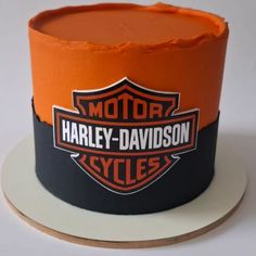 an orange and black harley davidson hat sitting on top of a white plate