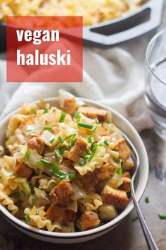 a white bowl filled with pasta and meat