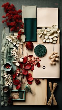 an arrangement of flowers, leaves and other items on a table with green accents in the center