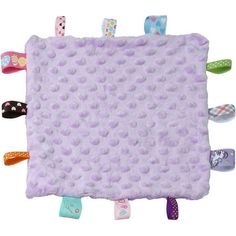 a purple blanket with lots of different colored hair clips on the bottom and one in the middle