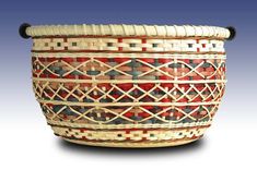 a woven basket is shown on a white background with red, blue and green accents