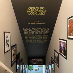 star wars memorabilia is displayed on the wall next to an escalator and stairs