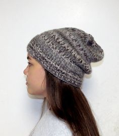 "Slightly slouchy beanie with a wide textured band in a mix of creams and brownish gray yarn. Warm grays range from off white to medium gray to a dark taupe gray.  Expertly seamlessly handknit for a comfortable fit. Classic styling is suitable for both men and women.  Yarn is soft 100% acrylic. Hand wash cold. Dry flat.  Hat measures 20\" round and 12\" from crown to brim, has a 3\" flat garter stitch band, and is reversible. Made in my smoke free, pet free studio. A beautiful way to stay warm!" Teen Hats, Knitted Wool Beanie, Flat Hat, Mens Beanie Hats, Knit Hat For Men, Greyish Brown, Grey Beanie, Dark Taupe, Wool Beanie