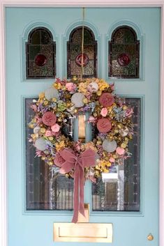 a blue front door with a wreath on it