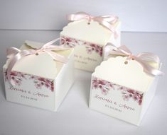 three small boxes with pink flowers on them