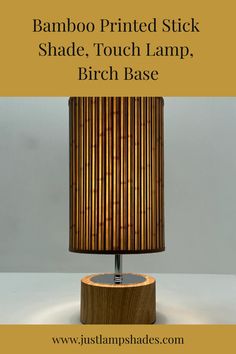 a lamp that is on top of a wooden base with the words bamboo printed stick shade, touch lamp, birch base