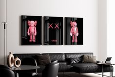 two pink teddy bears are hanging on the wall above a black leather couch in a modern living room