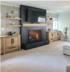 a living room filled with furniture and a flat screen tv mounted on the wall above a fire place